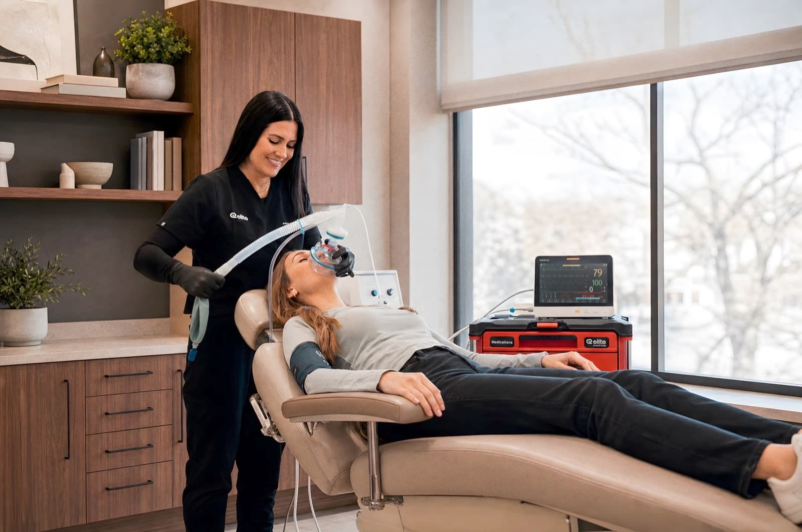 Elite provider administering sedation in a dental chair